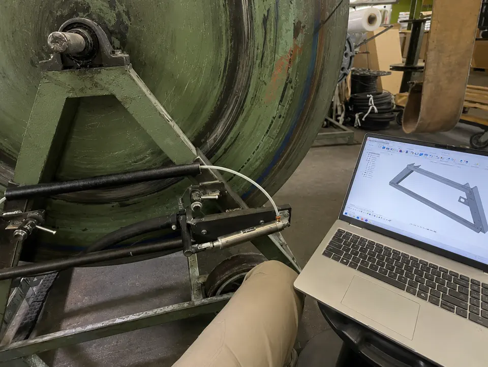 Custom hardware CAD model beside machine retrofit fit-up